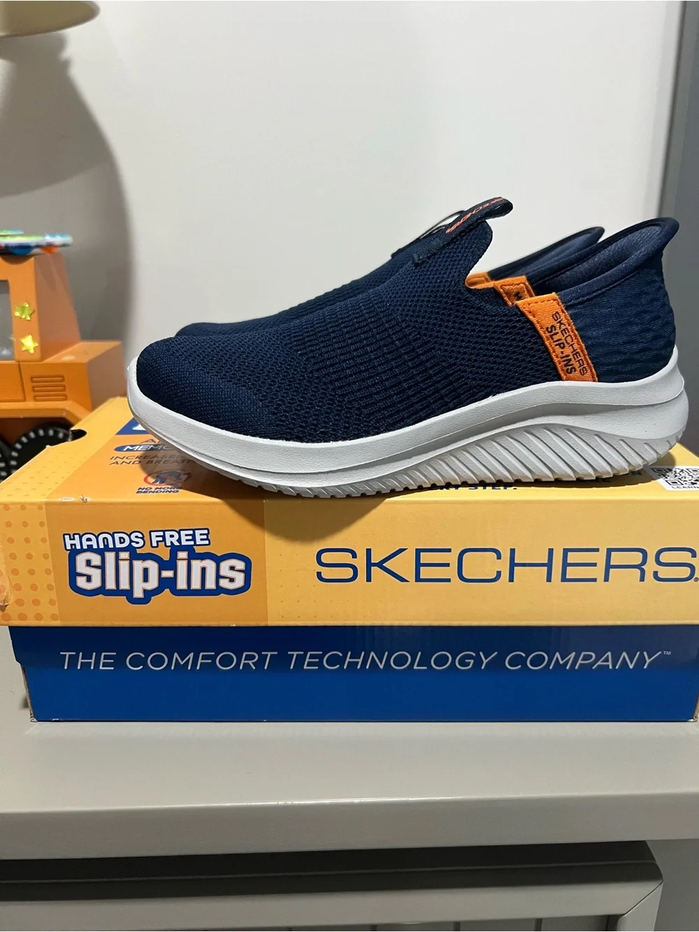 Skechers Kids Navy Slip-On Sneakers with Orange Pull Tab
